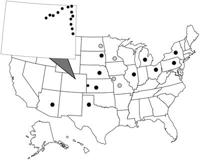 Patterns of Microbiome Composition Vary Across Spatial Scales in a Specialist Insect